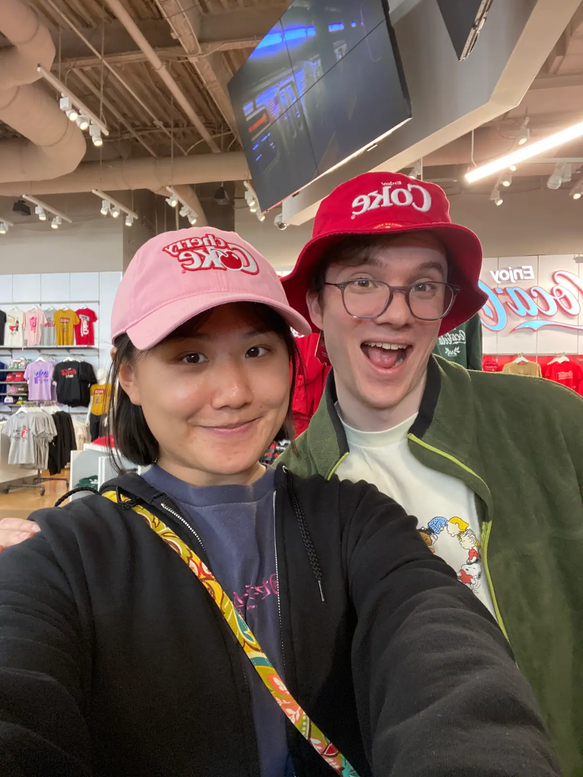 Angela and Sean trying on hats at the World of Coke