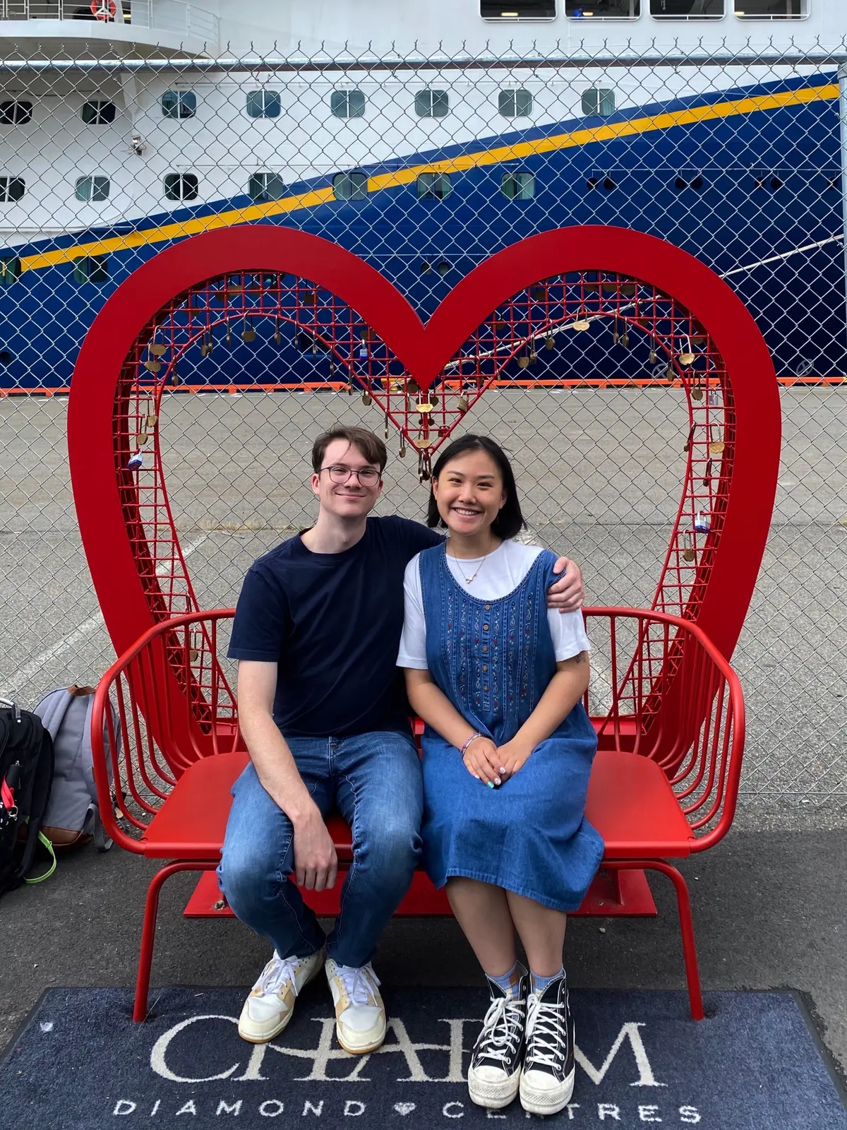 Angela and Sean sitting on a heart-shaped bench